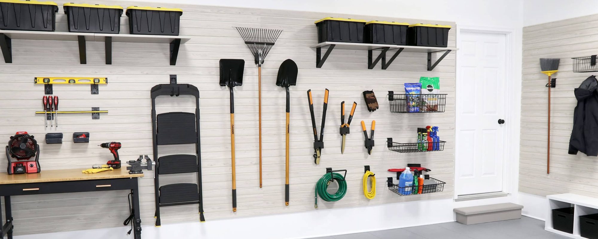 This image showcases a fully organized garage, illustrating the versatility and efficiency of the MKE Slatwall system. From tools and sports equipment to gardening supplies and automotive gear, everything is neatly stored and easily accessible. The MKE Slatwall system transforms any garage into a well-organized, clutter-free space, enhancing functionality and storage capacity. Featuring an array of slatwall hooks, shelves, and baskets, this setup exemplifies how tailored storage solutions can accommodate a variety of storage needs, ensuring that every item has its place. Upgrade your garage with MKE Slatwall and enjoy the convenience of a perfectly organized space.