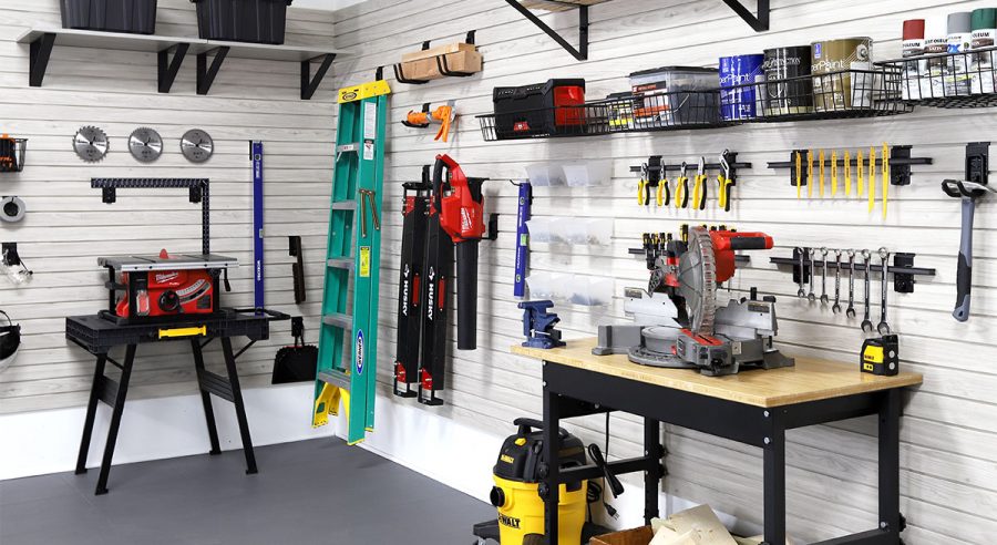 Close-up of tools organized on MKE Slatwall panels in a garage workshop.