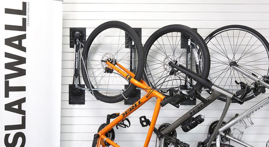 Organized garage with MKE Slatwall panels displaying various sports equipment.